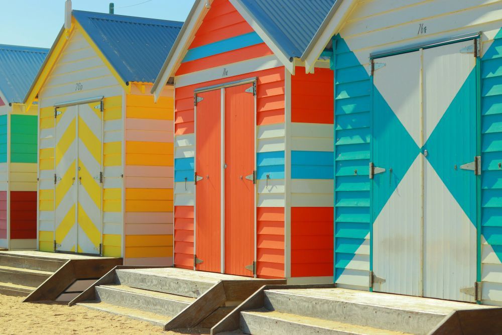 a-row-of-colorful-beach-huts-sitting-next-to-each-other-michael-shu-tv4wvu4cyju-unsplash.jpg